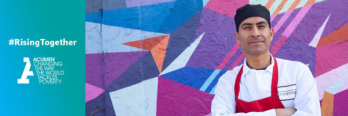 Chef standing in front of a colorful geometric wall mural